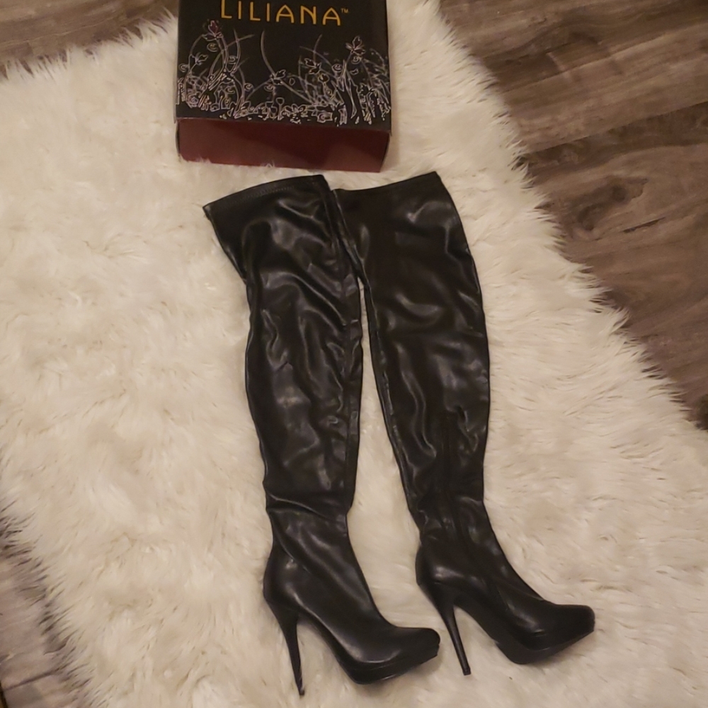 Black leather thigh high heeled boots